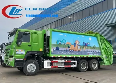 Rear view of the compactor truck with the loading gate open and the hydraulic dozer cylinder extended