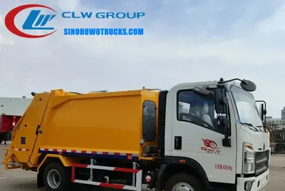 CNHTC HOWO 8cbm waste management truck in urban setting with compaction body and tail-lift