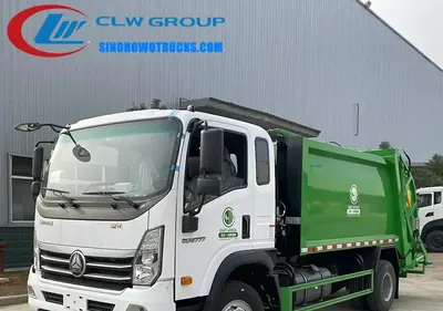 Sinotruk HOWO 4x2 rear-loading trash compactor truck in standard grey with rear compaction door open