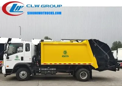 Rear view of the HOWO compactor truck with hydraulic lift arms and control panel at the rear