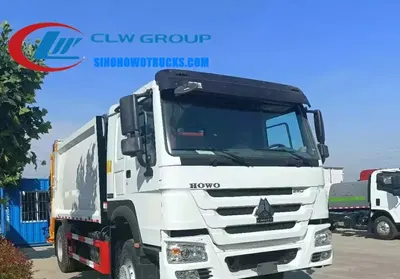 HOWO 12 ton compact garbage truck in urban waste collection service with rear loading mechanism engaged