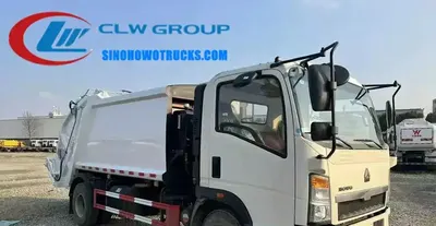 Sinotruk HOWO 4x2 refuse compactor truck with rear loader and 5.5 m³ compactor body in urban waste collection setting