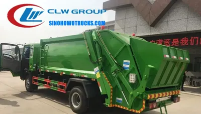Sinotruk HOWO 6 ton rear loading rubbish truck in urban waste collection service with rear compaction door open