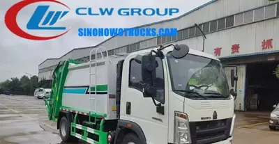 Side view of the HOWO compactor truck showing sealed body and hydraulic push plate mechanism