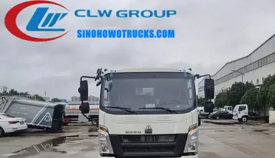 Rear loading hopper and push plate in operation on the HOWO refuse compactor truck