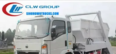 Howo 6tons skip waste truck in urban waste collection setting with swing arm lifting a sealed container