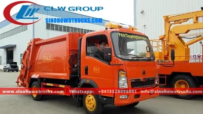 Rear view of HOWO compactor truck showing hydraulic compaction cylinder and loading hopper
