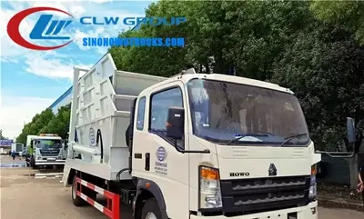 Side view of the mini skip truck showing swing arm system and bin lift mechanism