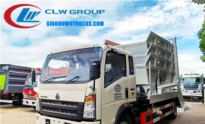 Rear view of the skip truck with open bin and sewage collection box visible