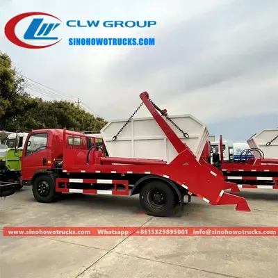 Rear view of the skip truck with the rear support leg deployed and the skip body being lifted