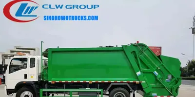 Side view of the HOWO compactor truck showing the loading hopper and hydraulic system