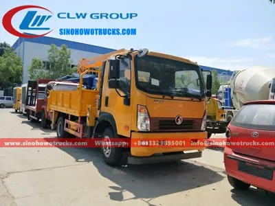 Rear view of the truck crane with the crane boom folded and the hydraulic system visible
