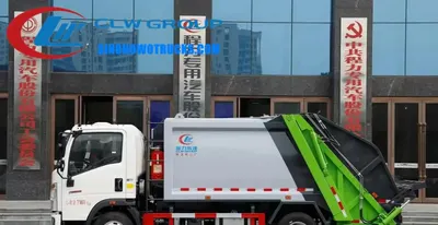 Sinotruk 5 ton rear load waste truck in urban setting with rear loading system in operation
