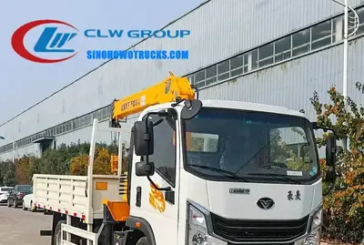 Rear view of the truck crane with the crane arm extended and hydraulic lines visible