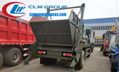 Side view of the HOWO skip lorry showing the high strength steel swing arm and 10m3 skip body