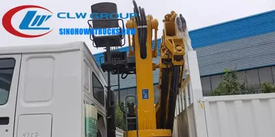 Side view of the HOWO truck mounted crane showing the knuckle boom and control panel