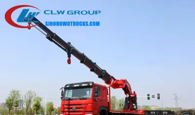 Sinotruk HOWO 110 ton construction crane truck in Sierra Leone with telescopic boom extended and crane operator in cab