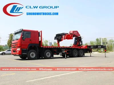 Side view of the HOWO crane truck showing the 8x4 chassis and high-strength steel cargo body