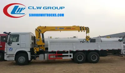 Side view of the HOWO truck crane showing the high-strength steel cargo box and crane mounting