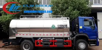 Side view of the HOWO dairy transport truck with front and side sprinklers activated