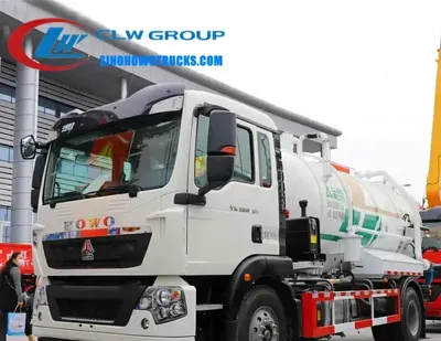 Side view of the HOWO sewage vacuum tanker showing the 5mm carbon steel tank and roller shutter access door