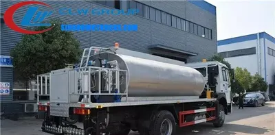 Sinotruk HOWO 12m3 bitumen lorry in road construction site with asphalt spray system active