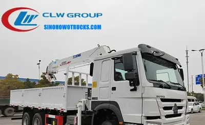 Side view of the HOWO crane truck showing the 6x4 chassis and telescopic boom in mid-lift position