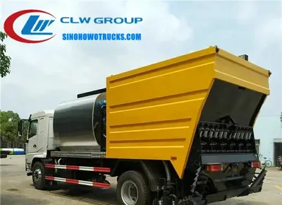 Sinotruk HOWO 14m3 asphalt concrete spreader truck in service with asphalt spray nozzles active