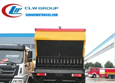 Rear view of the HOWO spreader showing gravel hopper and asphalt tank access doors