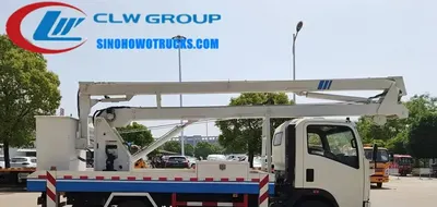 Sinotruk HOWO 14 meter man lift truck in urban setting with hydraulic boom extended and basket at height