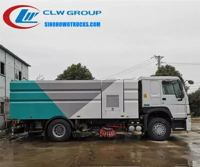 Side view of the HOWO sweeping truck showing stainless steel dustbin and vacuum suction nozzles