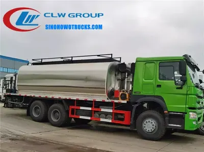 Sinotruk HOWO 6x4 asphalt distributor sprayer in road construction setting with spray system active