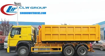 Side view of the HOWO roll off truck showing the 16m3 steel body and container lifting mechanism