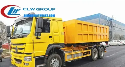 Rear view of the HOWO 16cbm container truck with the hook lift arm raised and container in position