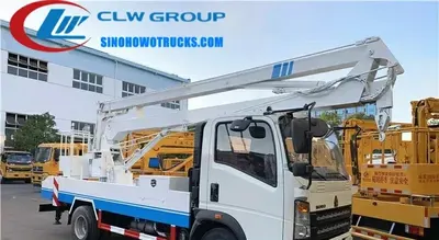 Close-up of the hydraulic outriggers and front support legs on the HOWO aerial lift truck