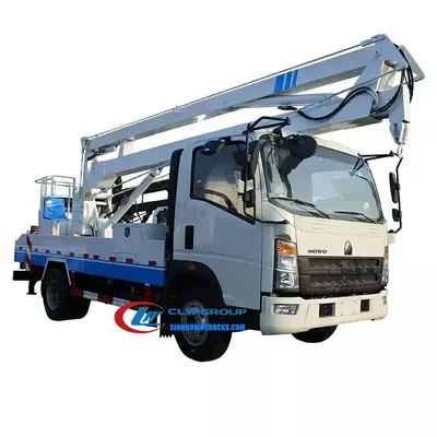 Sinotruk HOWO 16m cherry picker boom lift in urban setting with platform raised and outriggers deployed