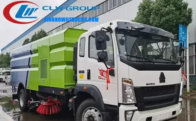 Sinotruk HOWO 16m3 street vacuum truck in white with stainless steel dustbin and sweeping brooms