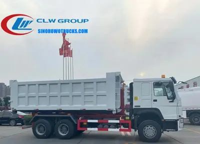 Sinotruk HOWO 18 ton roll off dumpster truck in service with hydraulic hook loader lifting a 22 cubic meter container