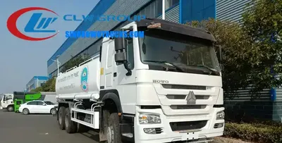 Sinotruk HOWO 6x4 water tanker truck in standard grey with front, rear and side spray nozzles active