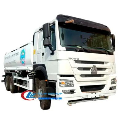 Side view of the HOWO water tanker with spray system and 12.00R20 tyres on rugged terrain