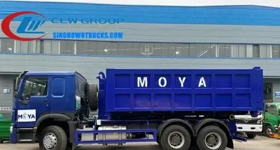 Side view of the HOWO 18cbm hook lift truck with a 20 cubic meter garbage container being lifted