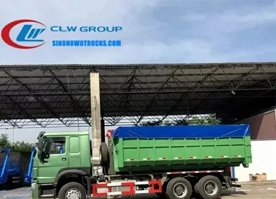 Rear view of the HOWO roll off truck showing the hook arm, rollers, and hydraulic cylinders