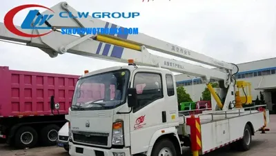 Sinotruk HOWO 18 meter truck mounted boom lift in urban setting with extended boom and work platform at height