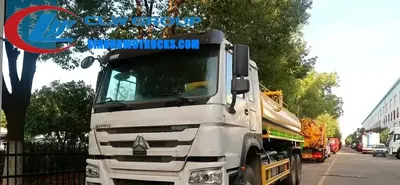 Sinotruk HOWO 6x4 septic vacuum truck in white with 18,000 litre tank and front-mounted vacuum pump