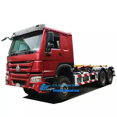 Rear view of the HOWO 20 ton roll off truck with the container being lowered onto the chassis