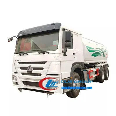 Side view of the water truck with front nozzle and side spray nozzles in operation