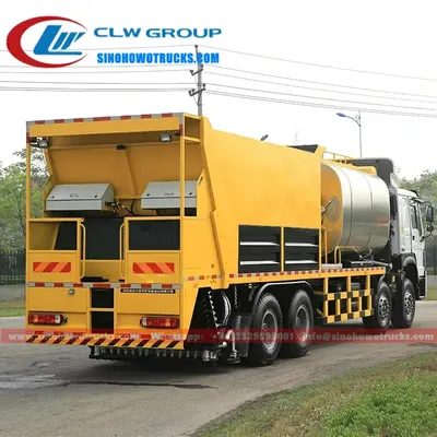 Rear view of the HOWO asphalt spreader showing the 14m3 gravel silo and 10m3 asphalt tank