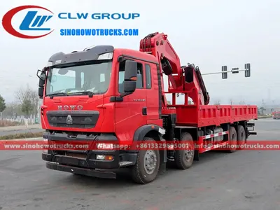 Side view of the HOWO crane truck showing the 7-section knuckle boom and cargo body