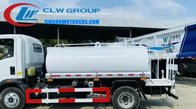 Sinotruk HOWO 4x2 mini water truck in white with front flush and rear spray nozzles in operation