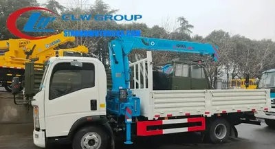 Rear view of the HOWO crane truck with the boom folded and the float three-point bridge structure visible